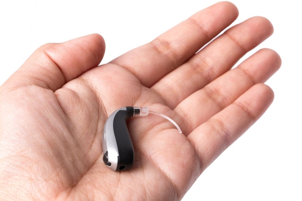 a hearing aid device on the palm