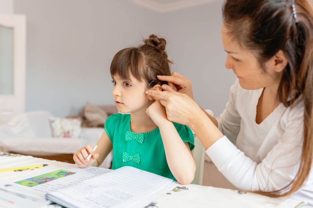 Mother helping daughters with homework