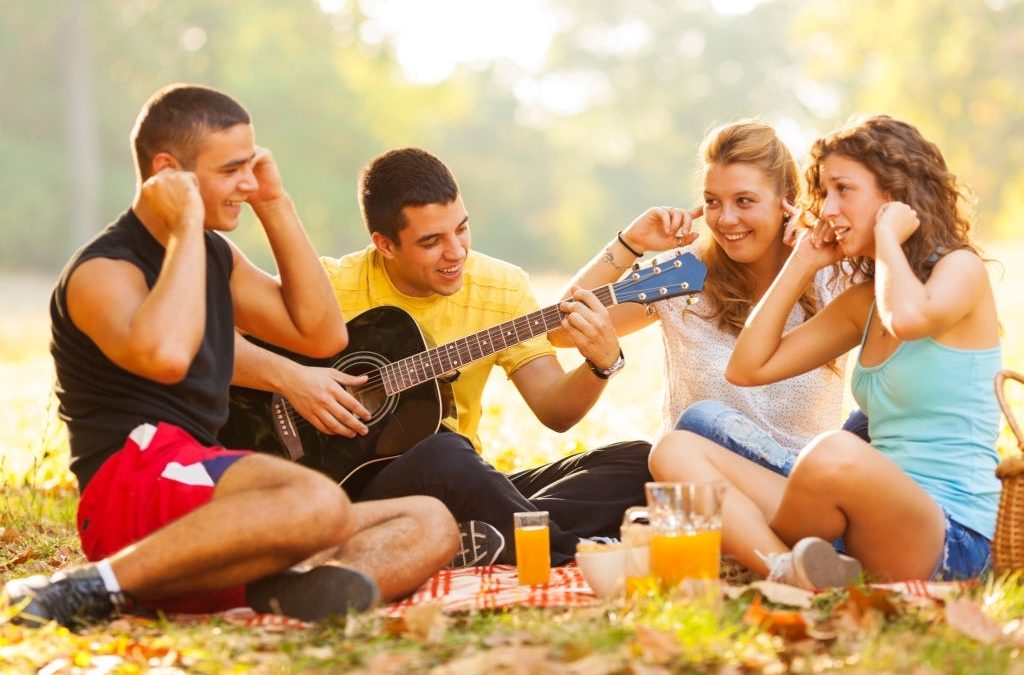 friends on picnic with an unwanted guitarist